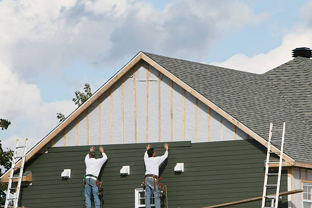 Professional Storm Damage Siding Repair technician working in Trenton, IL